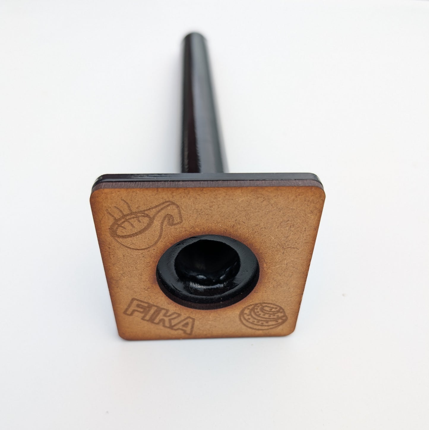 Underside of the Rullrån loading pin showing the engraved FIKA logo and branding.